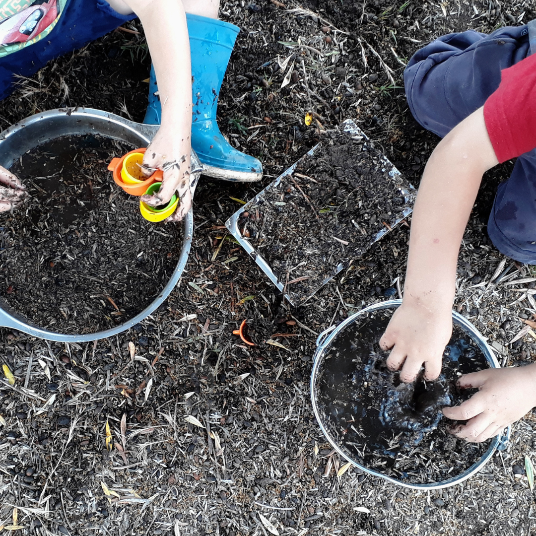 Children planting seeds outdoors