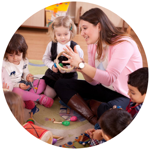 Early Years teacher in a classroom playing with children