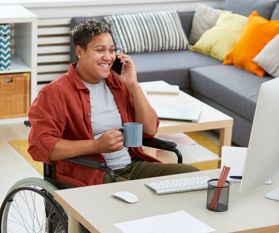 Disabled person on the phone in front of a computer