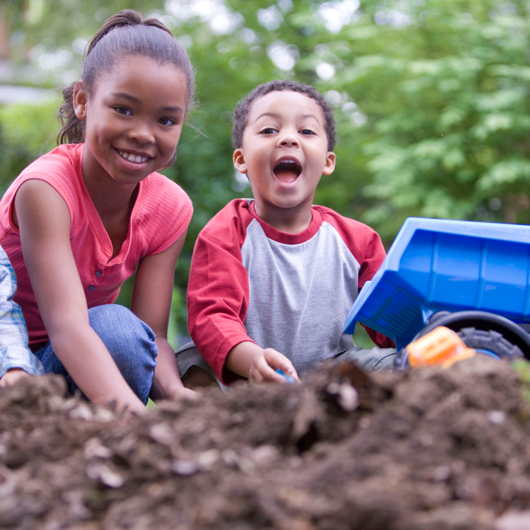 two children playing in the mud